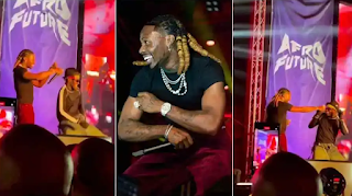 Asake rains dollars on lookalike in Ghana as he takes over stage at Afrochella (Video)